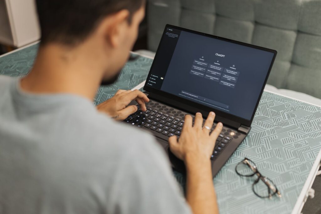 Professional using a digital assistant on a laptop