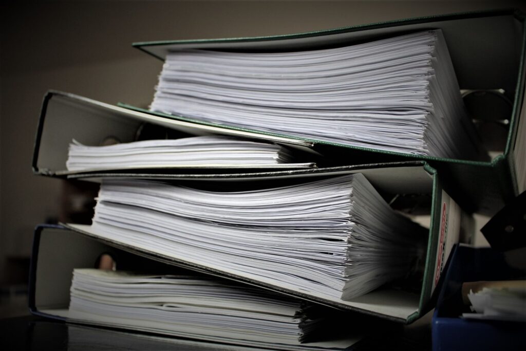 Documents and a laptop on a desk