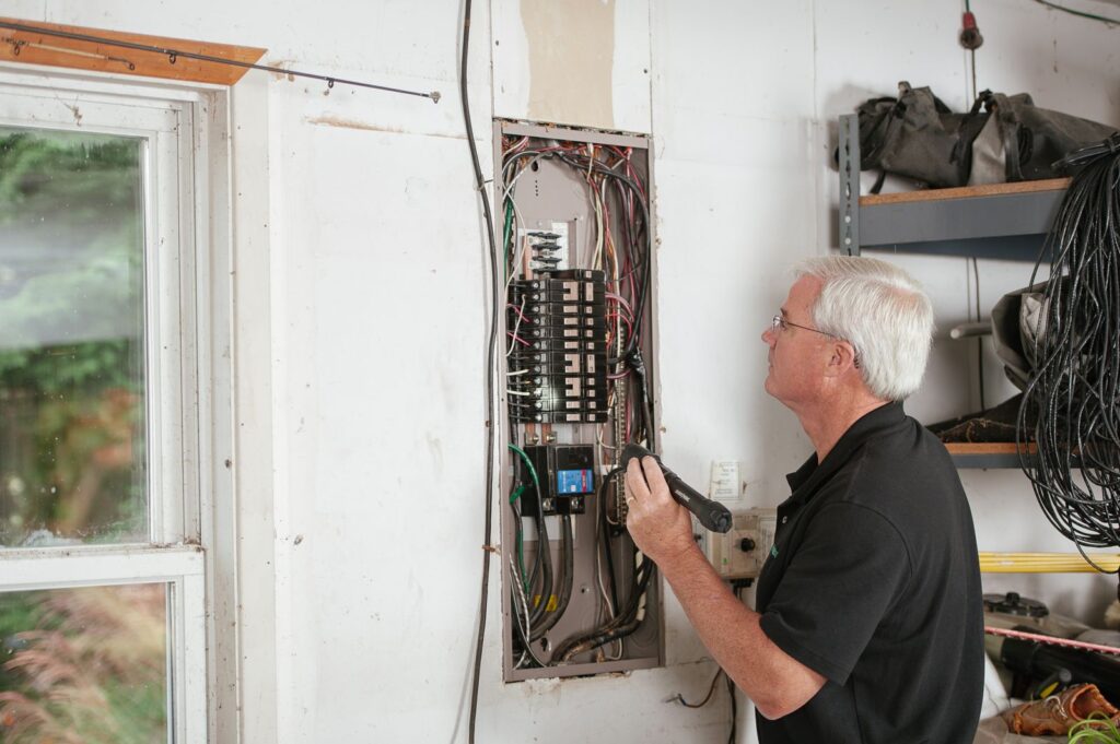 Technician at an electrical panel